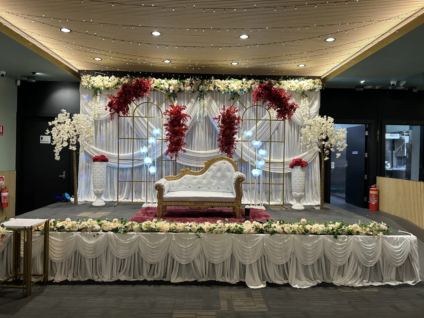 Decorated ceremonial stage inside The Vibes Venue