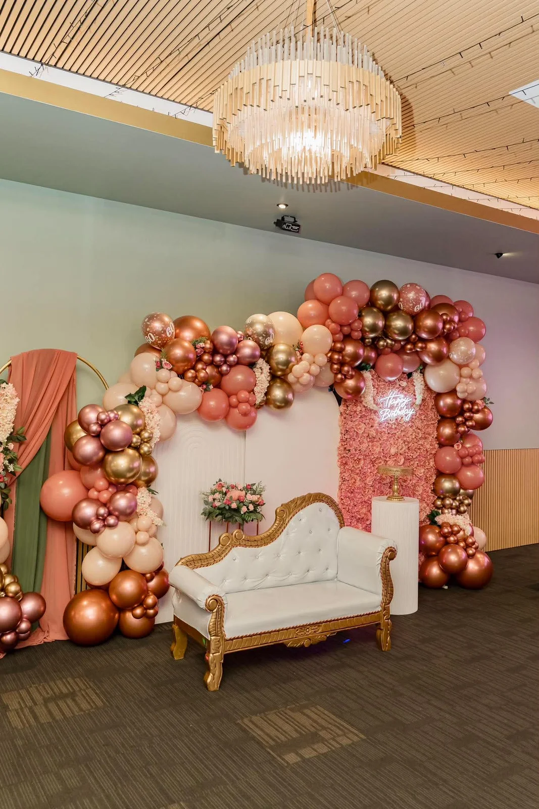 Pink and rose-gold balloon backdrop prepared at The Vibes Venue